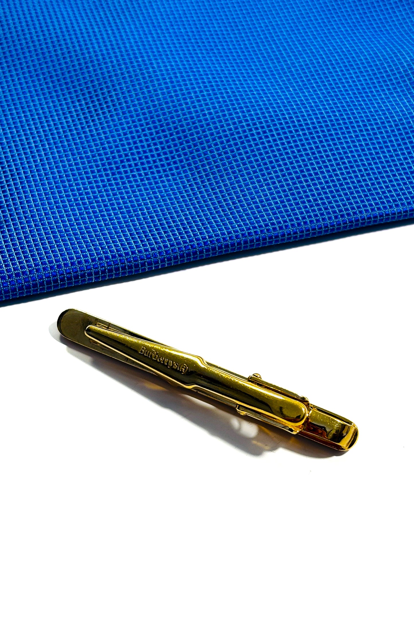 Gold plated Burberry tie clip.