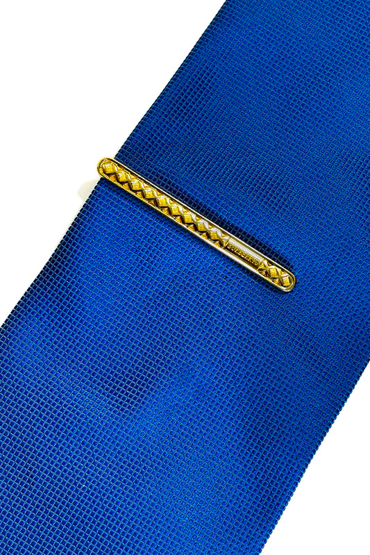 Gold plated Burberry tie clip.