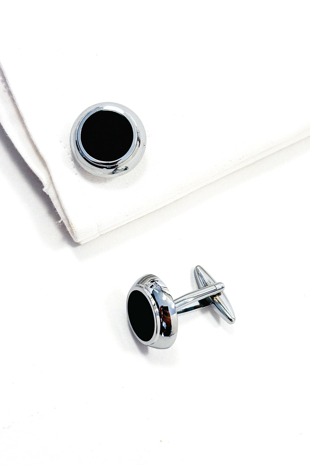 Silver cufflinks with black centres.