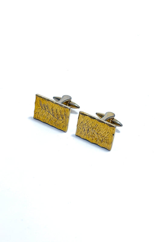 Stainless steel gold plated floral cufflinks.