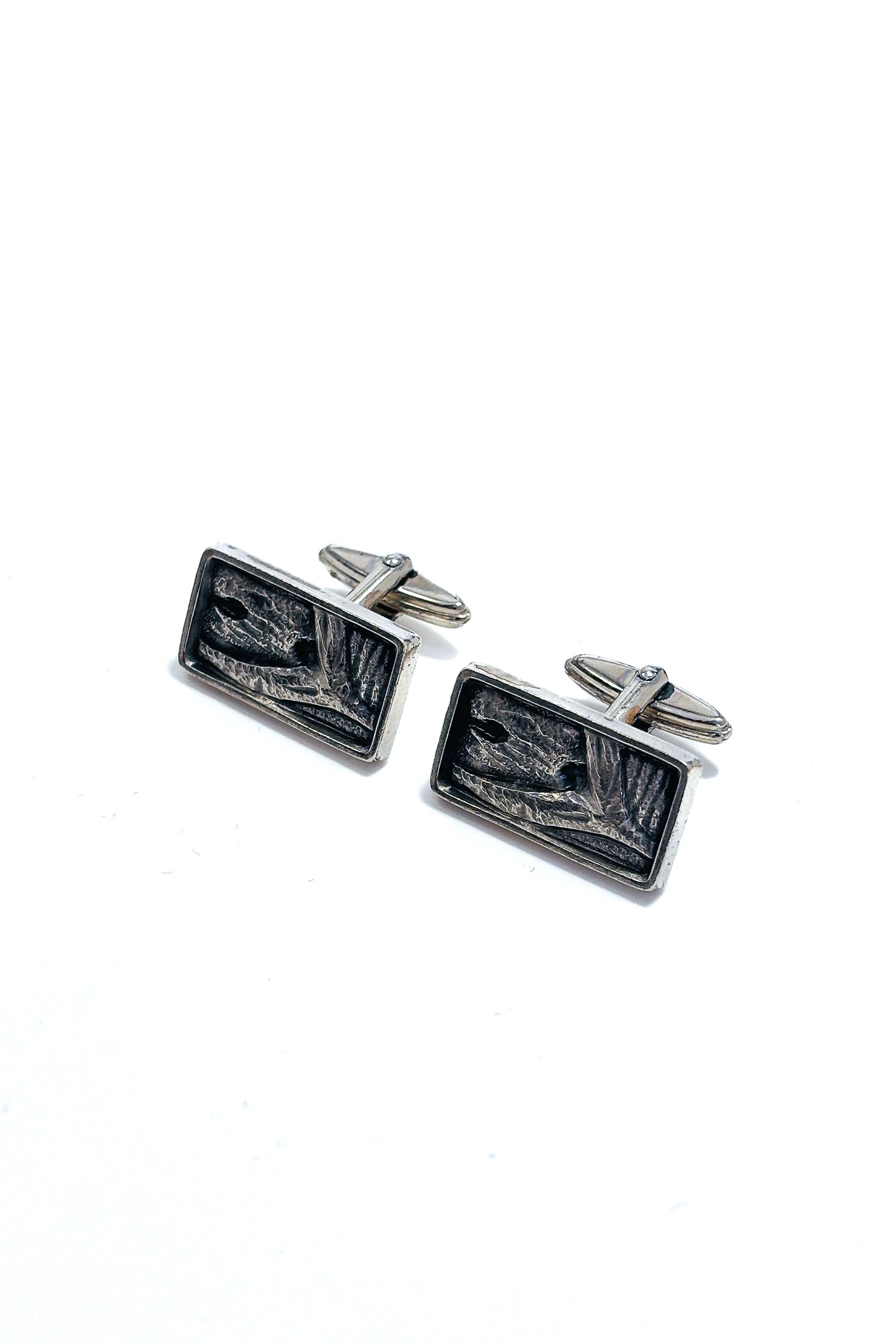 Stainless steel abstract whale tail design cufflinks.