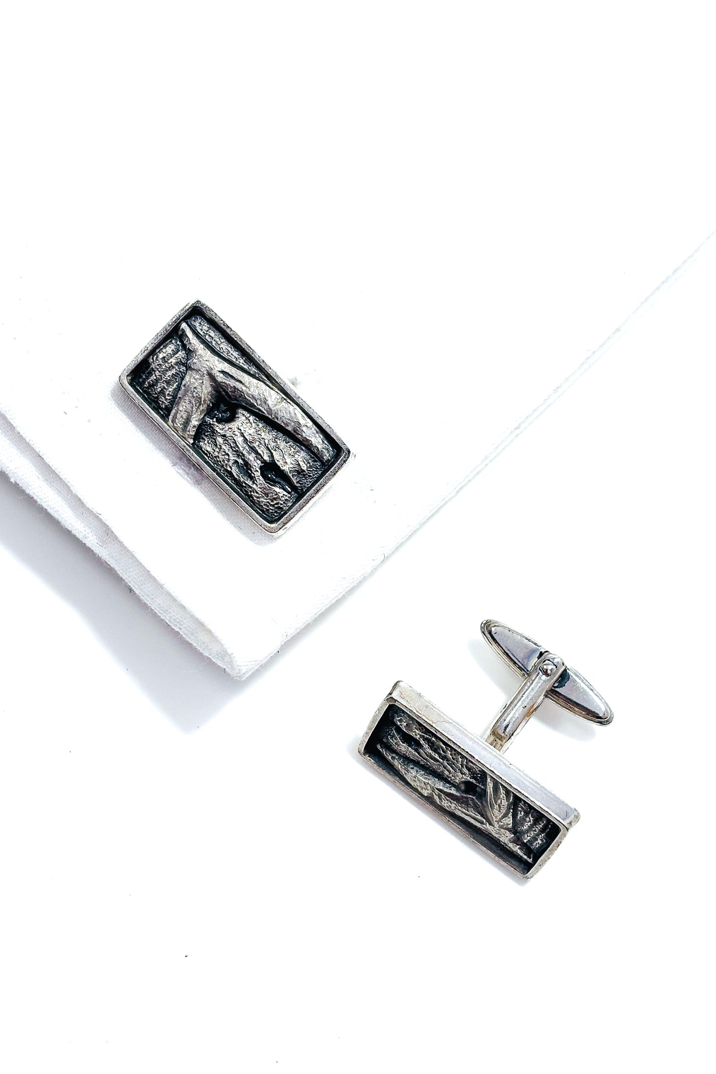 Stainless steel abstract whale tail design cufflinks.