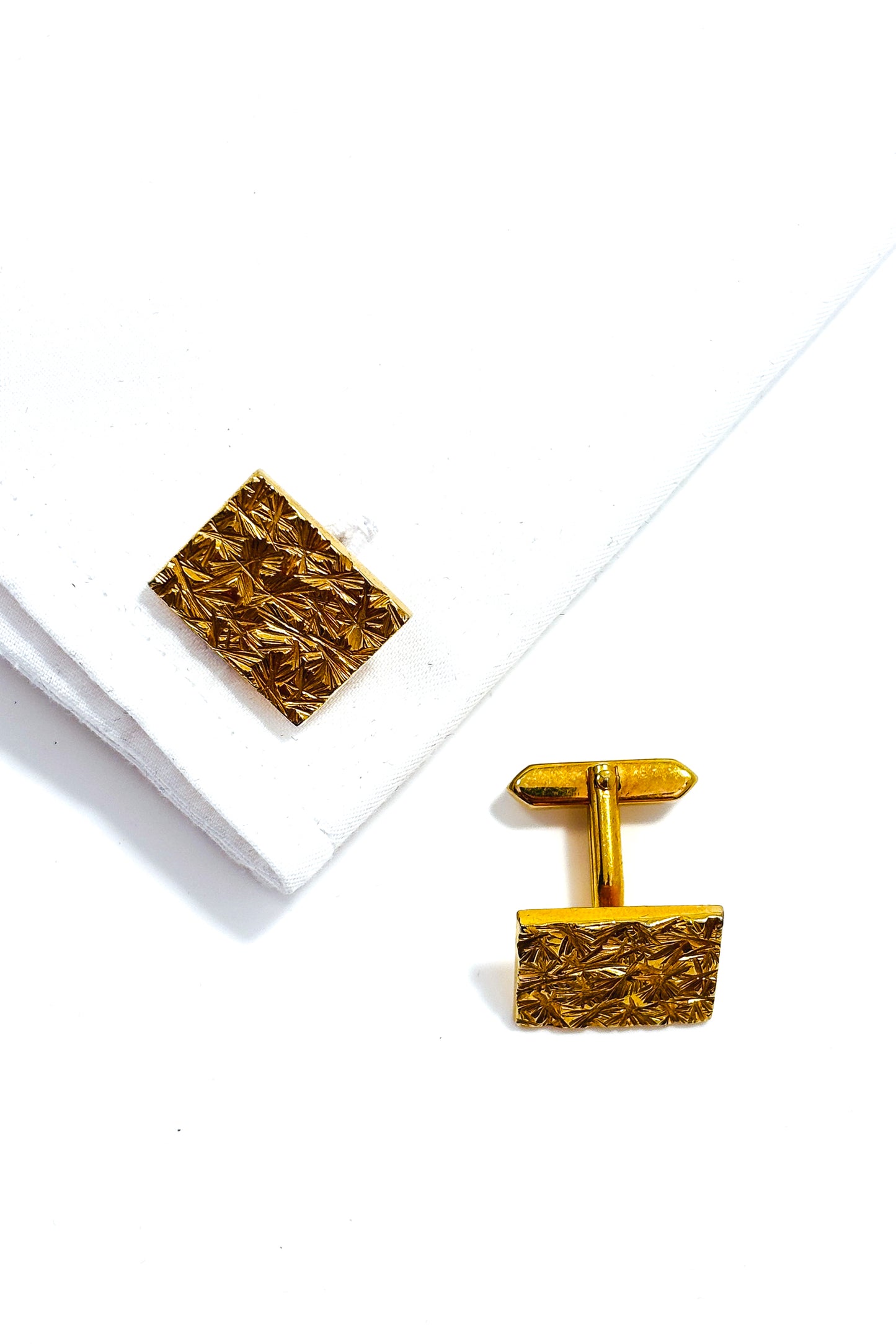 Stainless steel gold plated textured design cufflinks.